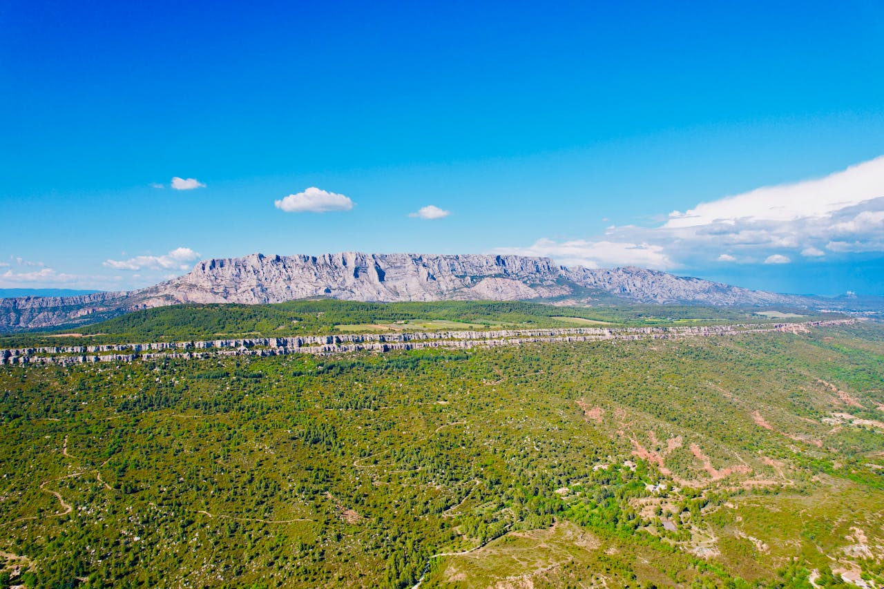 A breathtaking panoramic view of Montagne Sainte-Victoire under a clear blue sky.